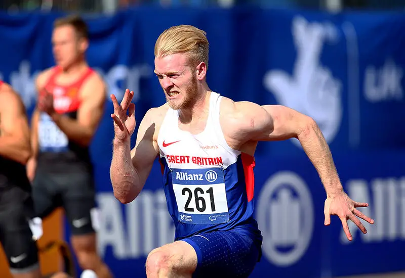 SWANSEA, WALES - AUGUST 19: Jonnie Peacock of Great Britain wins the mens 100m T44 final during day one of the IPC Athletics European Championships at Swansea University Sports Village on August 19, 2014 in Swansea, Wales. (Photo by Charlie Crowhurst/Getty Images)