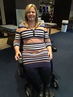 Lynley Adams in wheelchair at the office