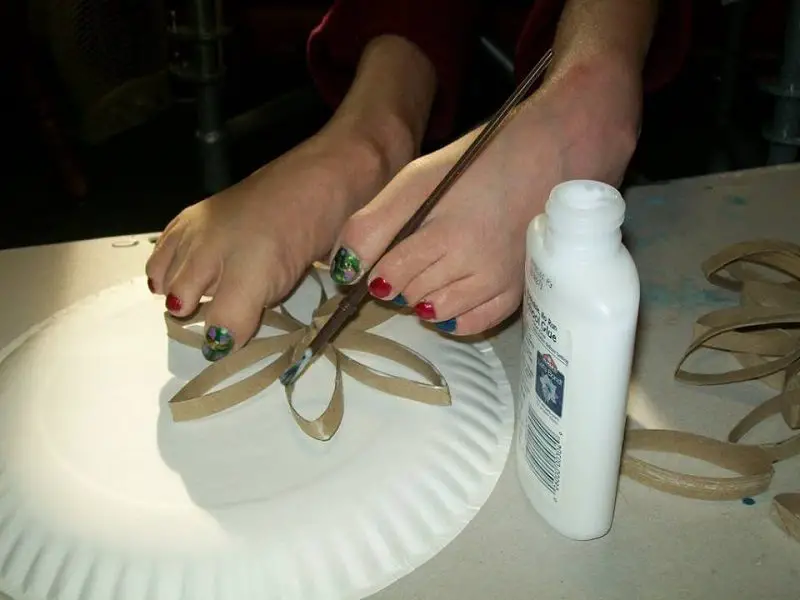 Meghan using her feet for a craft project