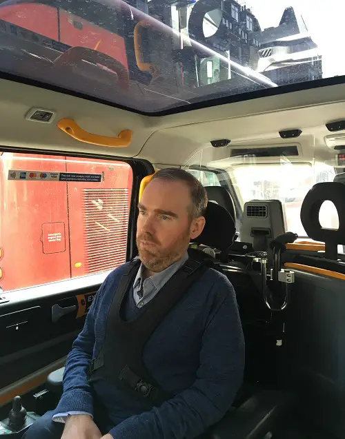 Toby Middleton in accessible black cab in his wheelchair