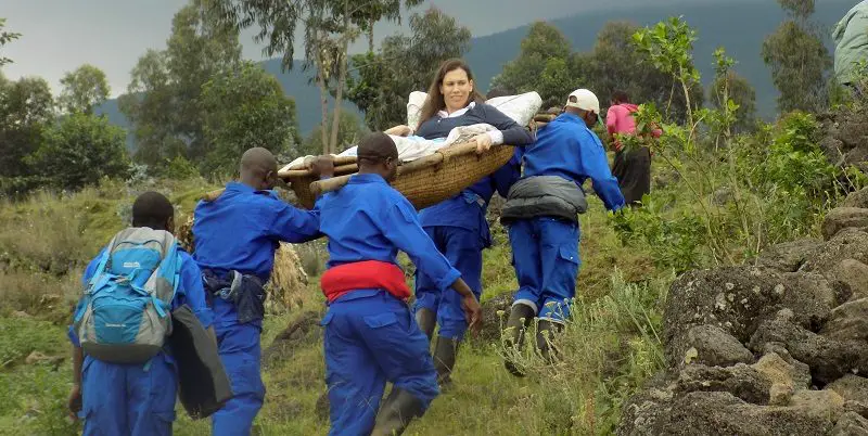Susie being carried up to see the gorillas on a stretcher