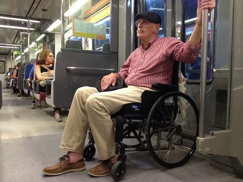 Wolf in his wheelchair on metro in Spain