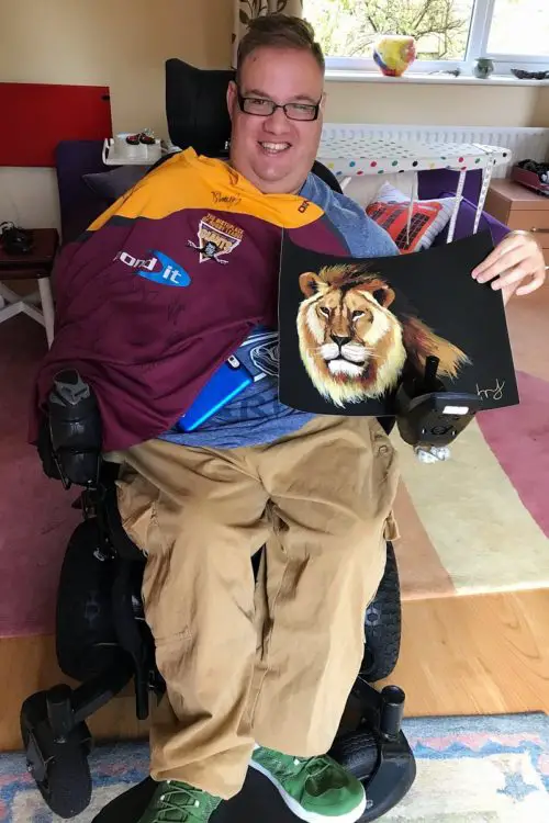 Wheelchair user Harry Newton with football shirt
