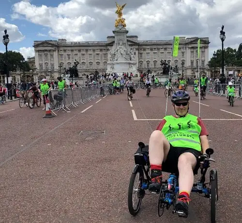 Nick outside Buckingham Palace in adapted bike