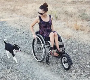 Woman using FreeWheel wheel on wheelchair