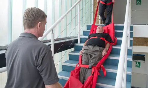 Disabled man strapped into a rescue sheet
