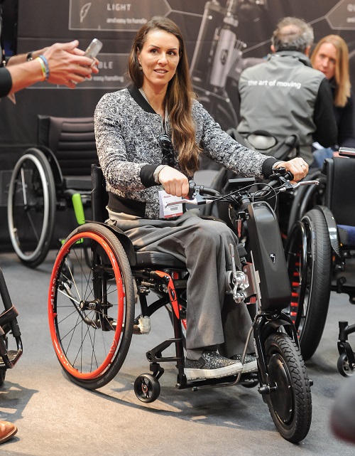 Disabled model Samanta Bullock trying a wheelchair at Naidex 2019