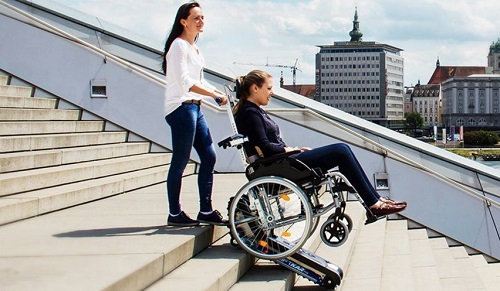Disabled woman in a stairclimer