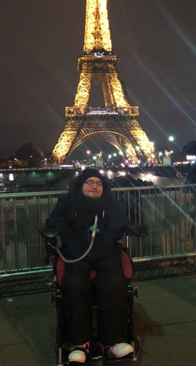 Wheelchair user Derry Felton in front of the Eiffel Tower