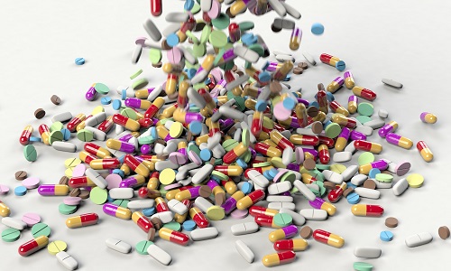 Lots of pills being tipped onto a pile