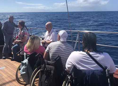 A group of disabled travellers on a boat on a disabled-friendly holiday