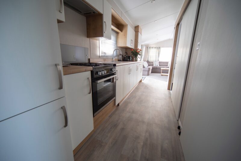 Accessible caravan kitchen with fridge, oven,, sink, toaster, kettle and cupboards