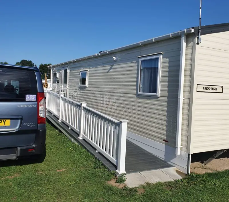 Front of accessible caravan with accessible ramp and car park space