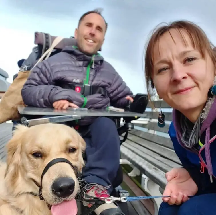 Martyn Sibley in his wheelchair outside with Kasia and dog sunny sat in front