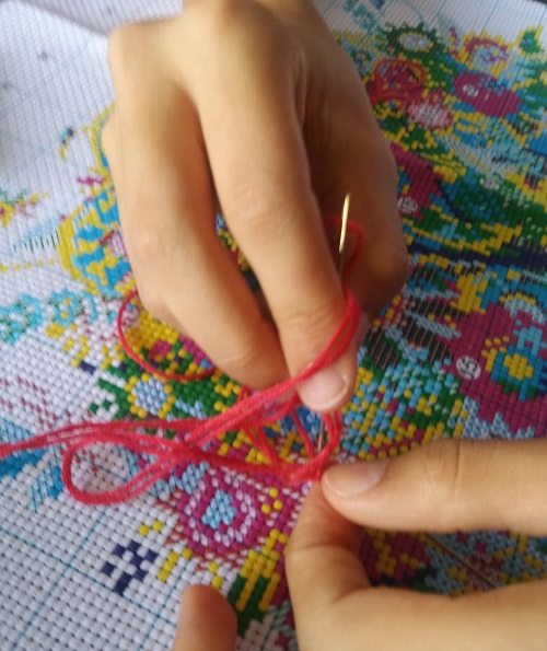Cross stitch being stitched