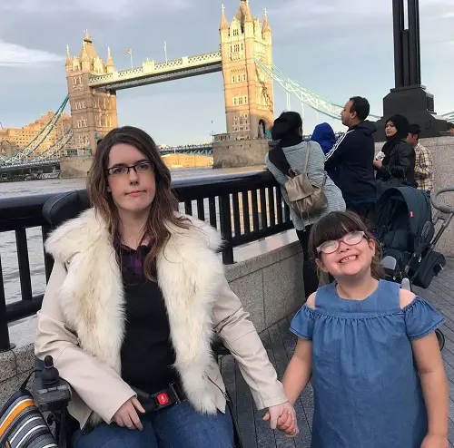 Fi Anderson in her wheelchair with her daughter in front of Tower Bridge in London