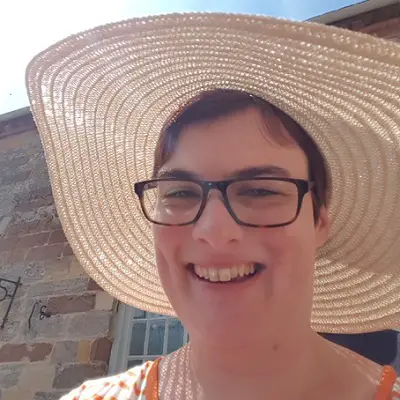 Lucy Currier outside in a sunhat