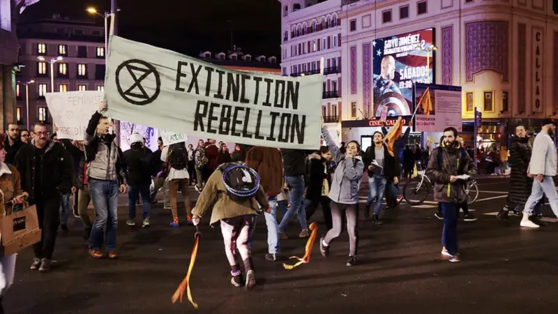 Extinction Rebellion sign at protest in London at night