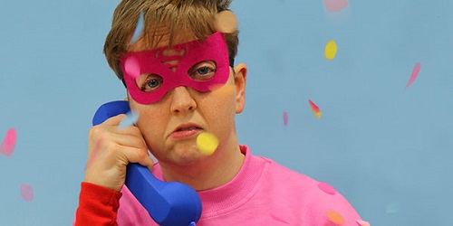 Man with pink outfit and eye mask as advert for show Scrounger