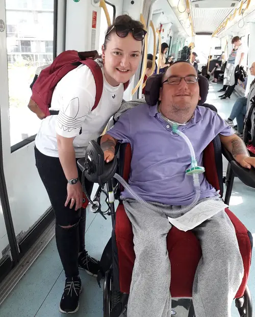 Wheelchair user Derry and his PA on an accessible train in Copenhagen