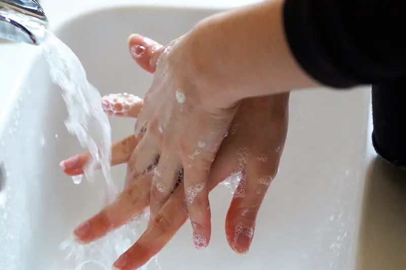 Back of hands between the fingers being washed