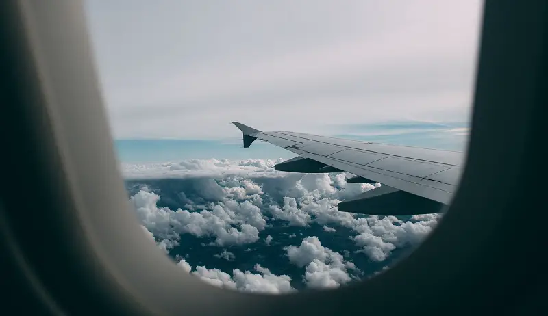 Airplane wing seen through an airplane window