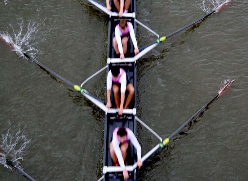 Image taken from above by blind photographer Roesie Percy of female rowers in pink tops