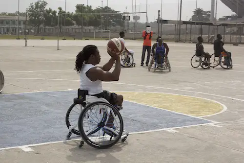 Ade Adepitan playing basketball