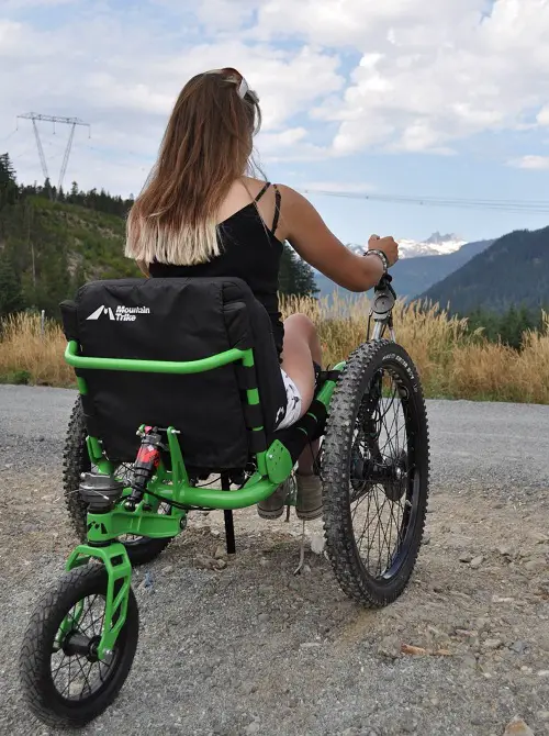Laura May in her Mountain Trike wheelchair in Whislter on a mountain top looking at other cliffs