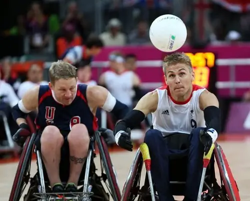 Steve Brown on the court playing wheelchair rugby at the Paralympic Games 2012 with him about to catch a rugby ball in the air