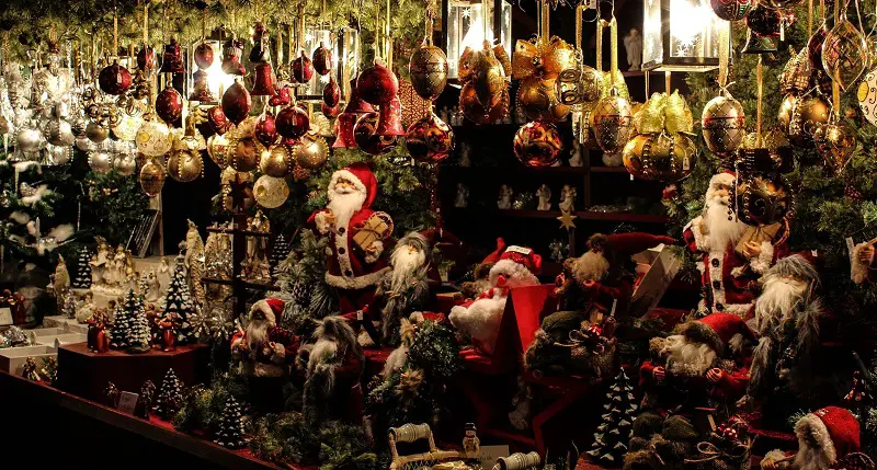 Christmas market stall filled with baubles and Santa statues