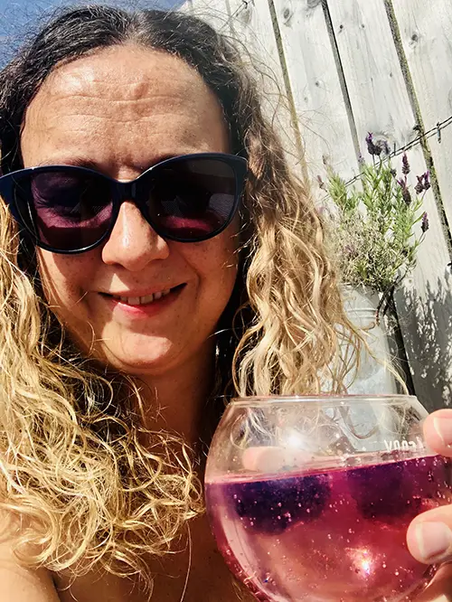 Carrie-Ann Lightley is in the garden holding a cocktail