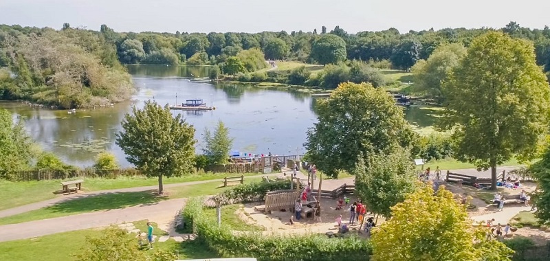 Wheelchair-accessible Ferry Meadows Nene Park with a large lake surrounded by park and trees and a playground