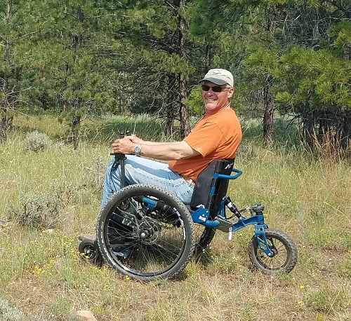TJ Woosley on his Mountain Trike all-terrain wheelchair in a forest in the USA