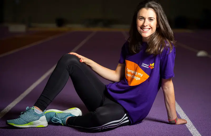 Paralympian Livvy Breen sat on a race track smiling