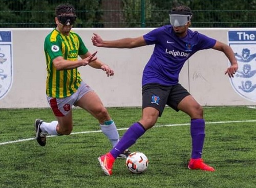 Azeem wearing a blindfold playing blind football