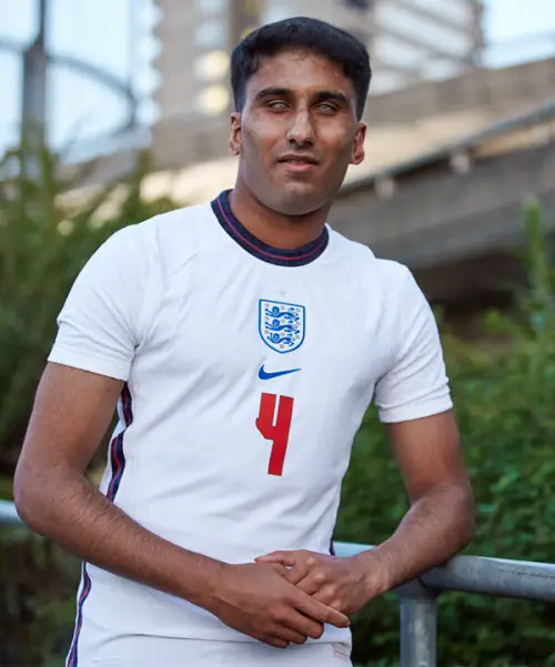 Blind footballer Azeem wearing an England football shirt