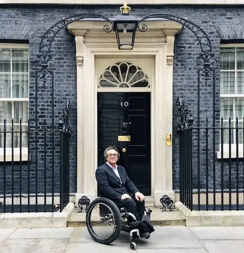 Grant Logan wearing a suit sat in his wheelchair outside Number 10 Downing Street