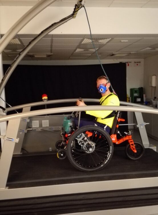 A man on a treadmill using Mountain Trike all-terrain wheelchair