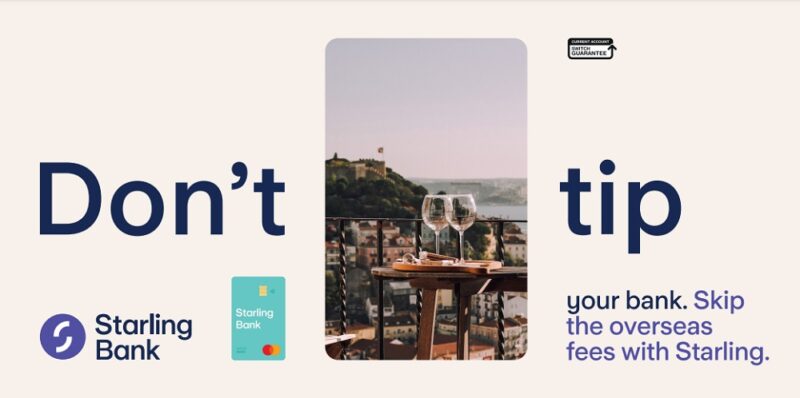 Starling Bank no fees travel card banner showing an image of a table and two wine glasses on a terrace in front of a lake with the words 'Don't tip your bank. Skip the overseas fees with Starling' at each side of it with the Starling Bank logo