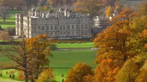 Longleat country house in the distance with trees in autumnal colours in front of it