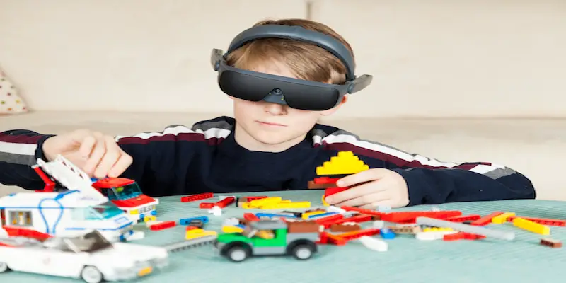 Boy Playing with Building Blocks wearing his eSight Device