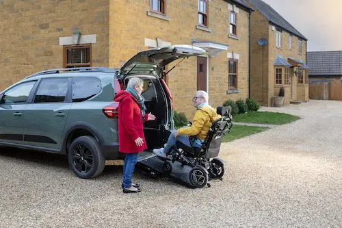 Dacia Jogger Wheelchair-Accessible Car - wheelchair user at rear of car going up ramp