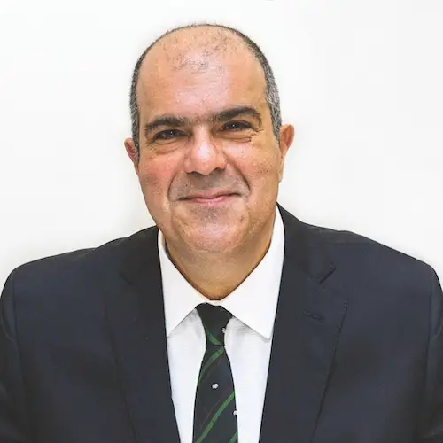 Sir Stelios Haji-Ioannou in a black jacket tie and white shirt, smiling
